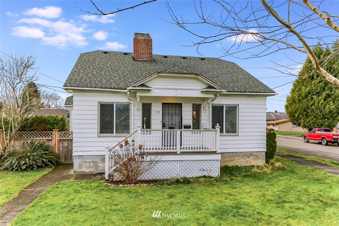 129 Wells Avenue North Renton, WA 98057 - Photo 2 of 29 a front view of a house with a garden