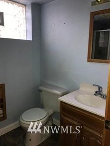 129 Wells Avenue North Renton, WA 98057 - Photo 18 of 29 a bathroom with a sink toilet and window