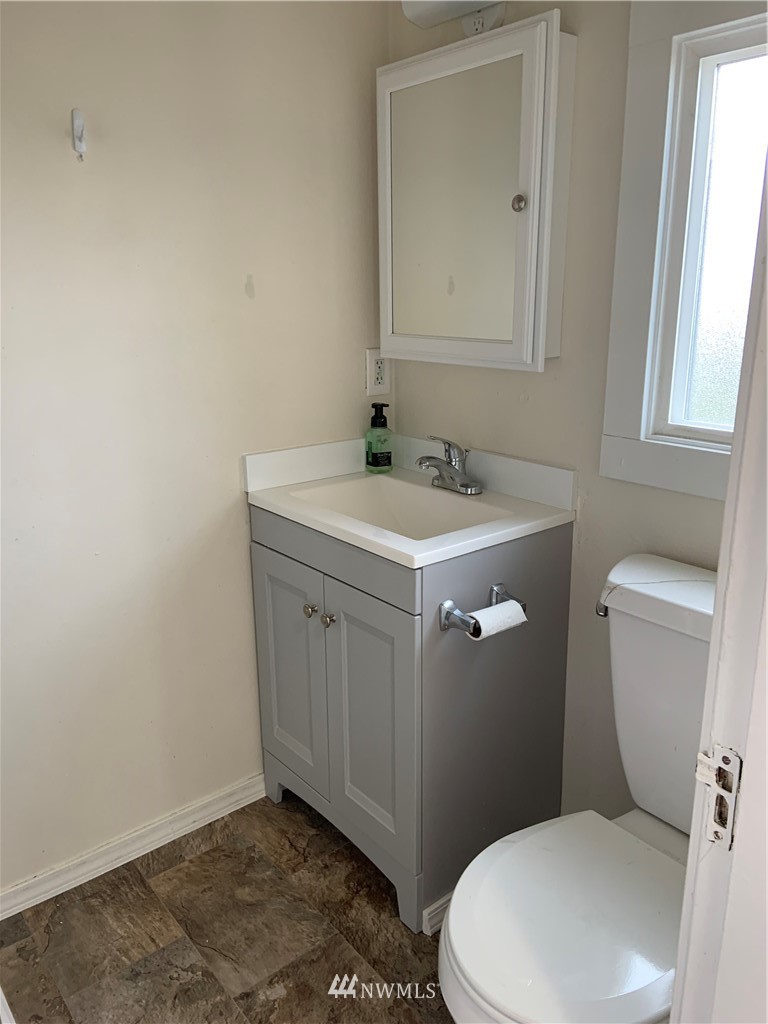 129 Wells Avenue North Renton, WA 98057 - Photo 27 of 29 a white toilet sitting next to a bathroom sink