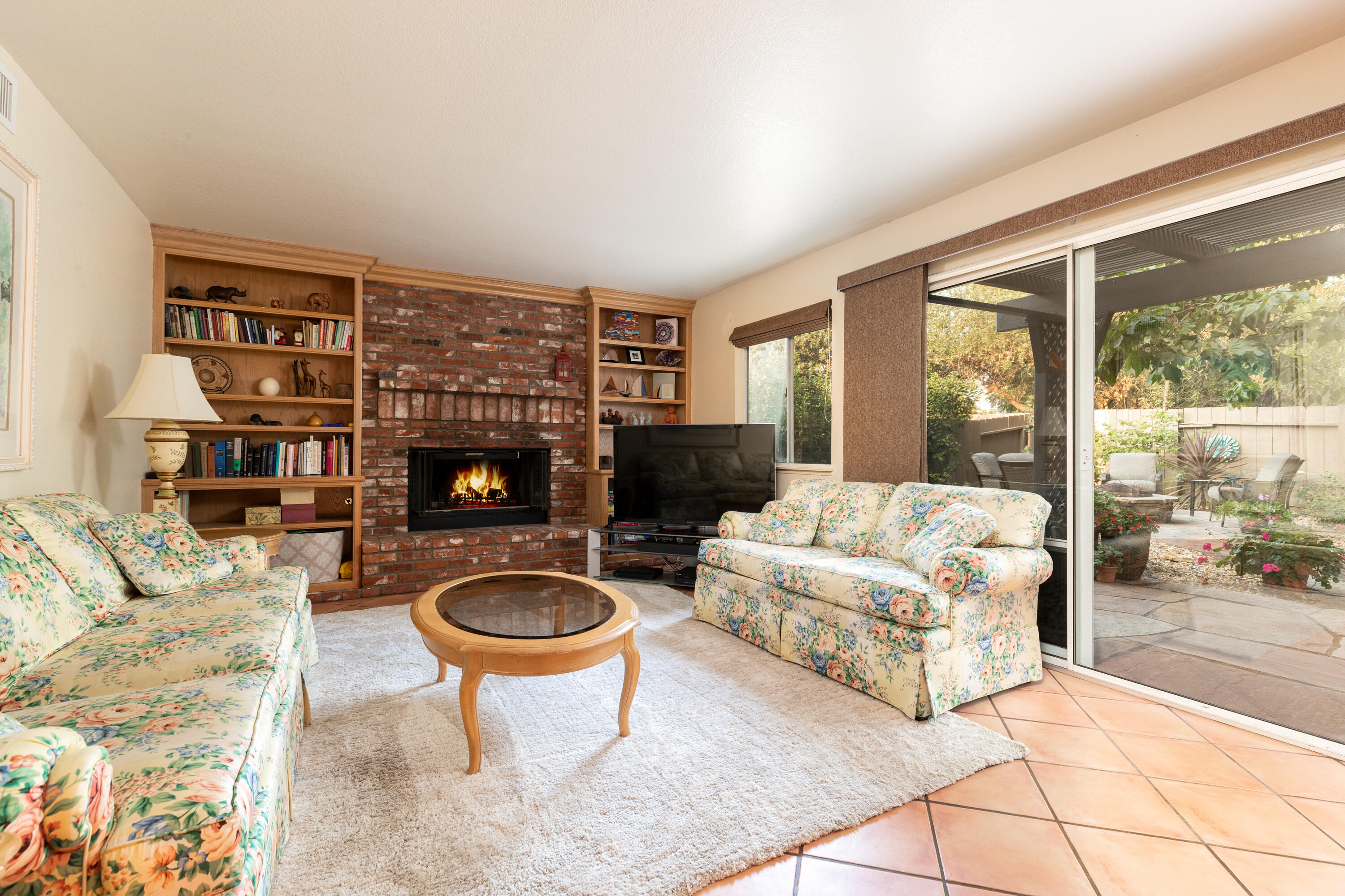 352 Nykobing Solvang, CA 93463 - Photo 8 of 27 a living room with furniture a fireplace and a floor to ceiling window