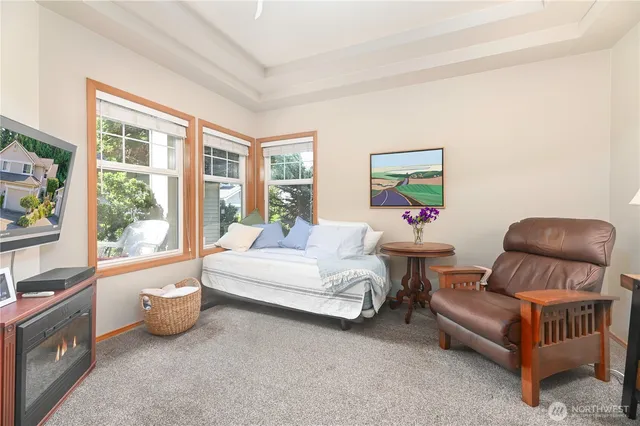 a spacious bedroom with a bed and a large window