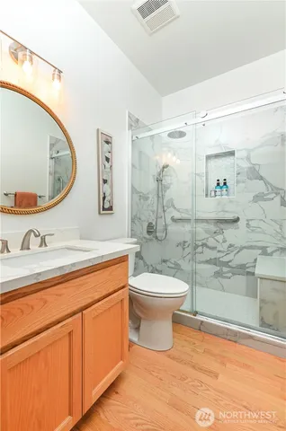 a bathroom with a toilet a sink and mirror