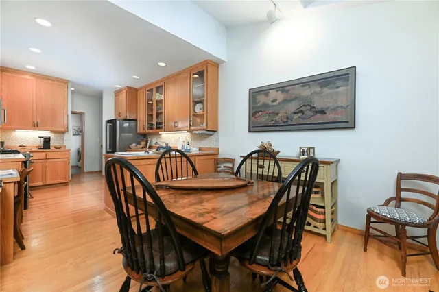 a view of a a dining room with furniture window and wooden floor