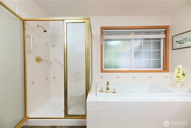 a bathroom with a bathtub and a shower