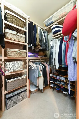 a view of walk in closet with clothes and shoes