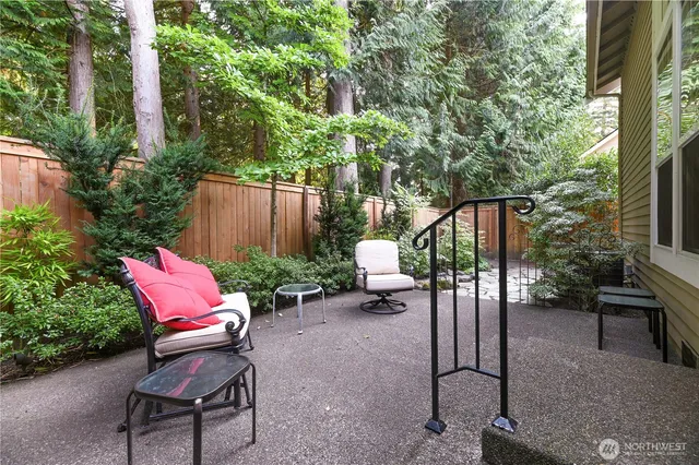 a view of a backyard with sitting area and garden