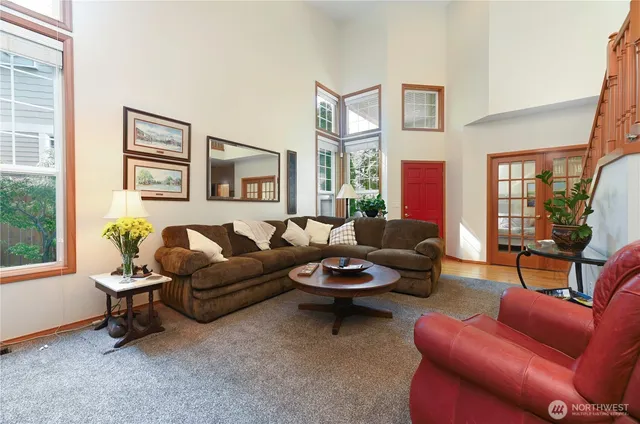 a living room with furniture a rug and a window