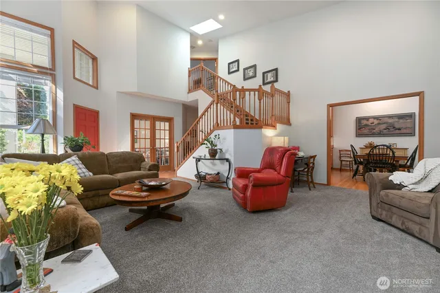 a living room with furniture and a chandelier