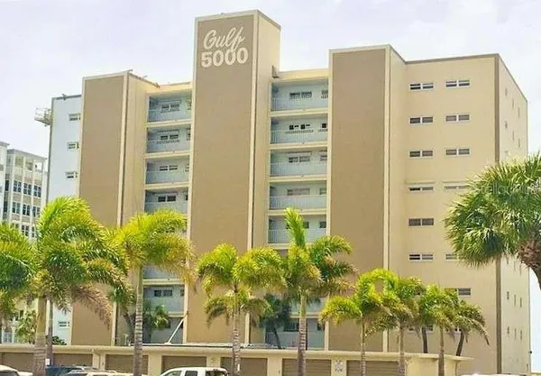 a front view of a building with palm tree