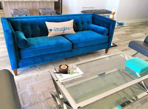 a kitchen with kitchen island granite countertop a table chairs sink and cabinets