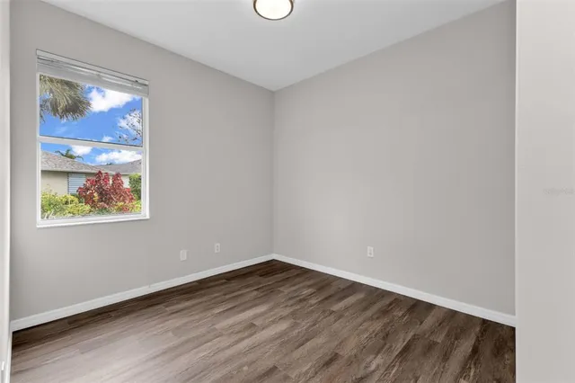 wooden floor in an empty room with a window