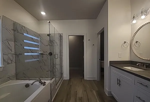 a bathroom with a granite countertop sink mirror vanity and toilet
