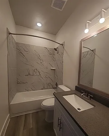 a kitchen with kitchen island granite countertop a stove a sink and a microwave