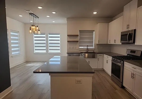 a view of a room with wooden floor and windows