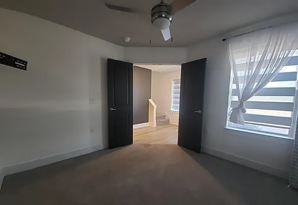 a view of a big room with windows and chandelier
