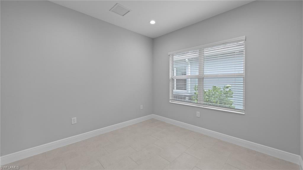 4636 Skysail Drive Naples, FL 34120 - Photo 19 of 46 an empty room with a window