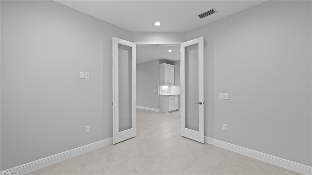 4636 Skysail Drive Naples, FL 34120 - Photo 20 of 46 a view of a hallway with wooden shelves
