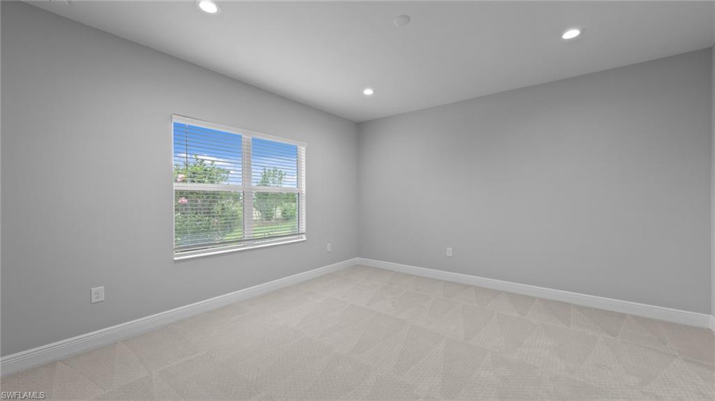 4636 Skysail Drive Naples, FL 34120 - Photo 21 of 46 an empty room with windows