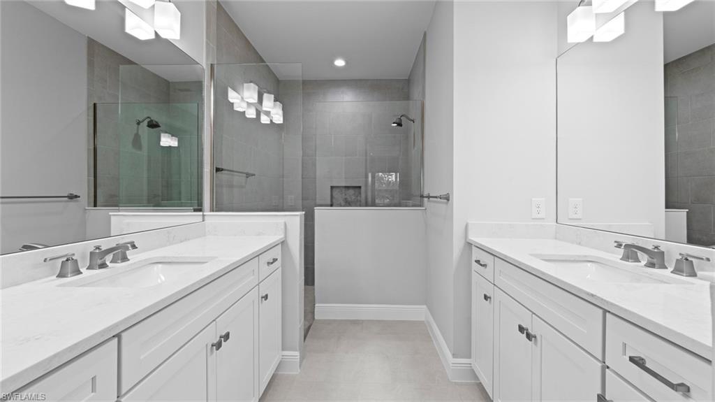 4636 Skysail Drive Naples, FL 34120 - Photo 24 of 46 a spacious bathroom with a double vanity sink and a mirror