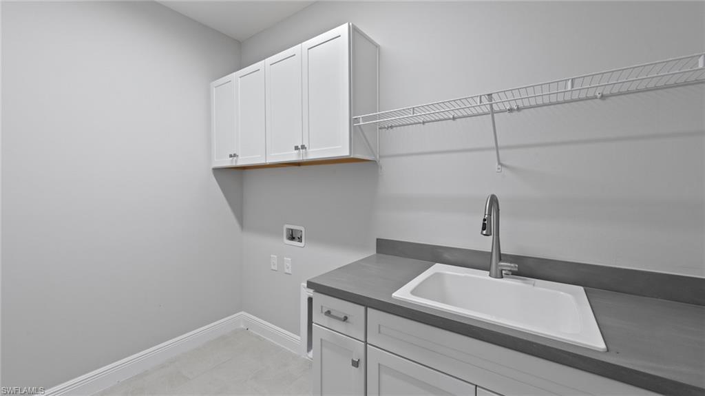 4636 Skysail Drive Naples, FL 34120 - Photo 26 of 46 a kitchen with a sink and cabinets