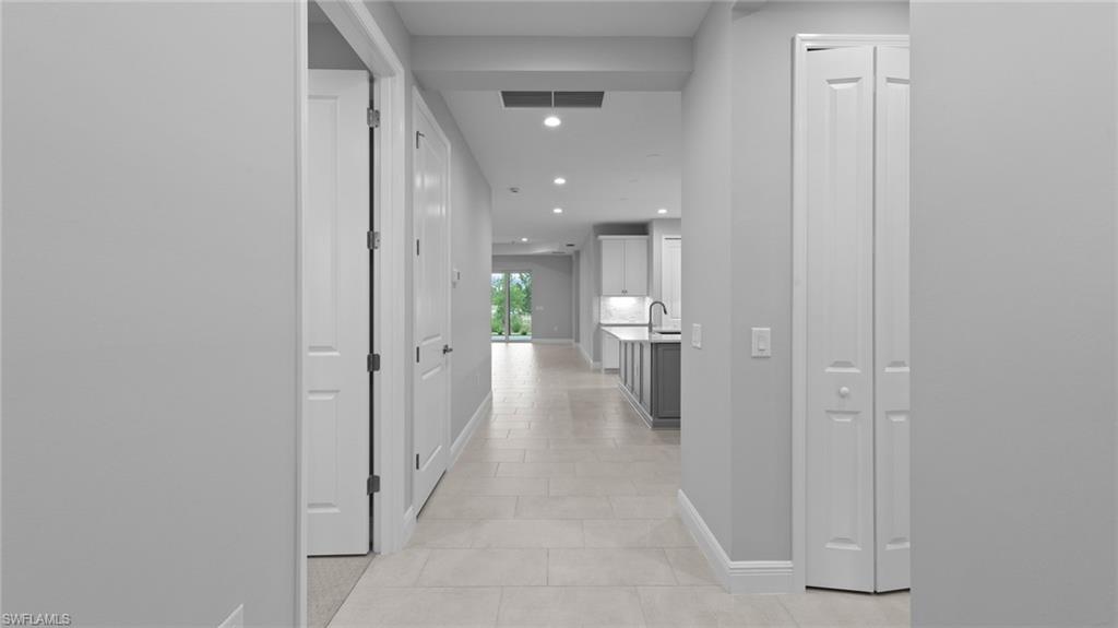4636 Skysail Drive Naples, FL 34120 - Photo 4 of 46 a view of a hallway with a livingroom and a bathroom
