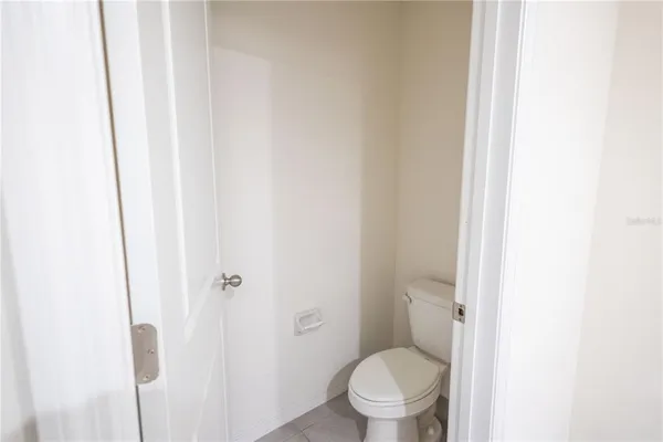 a white toilet sitting next to a shower