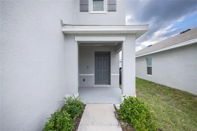 a view of a house with a small yard