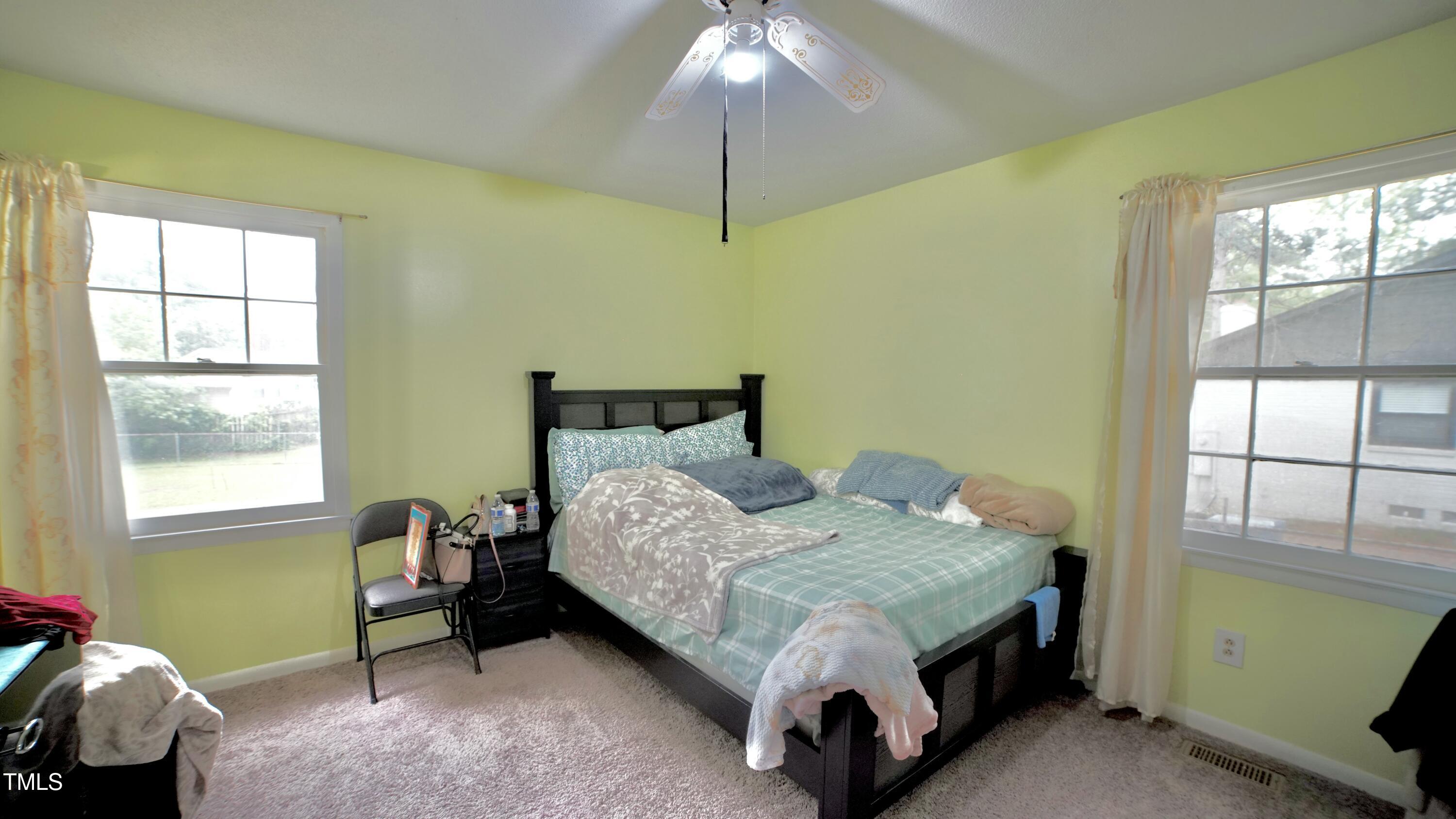 1011 Wyldewood Road Durham, NC 27704 - Photo 11 of 18 a bedroom with a bed and a window