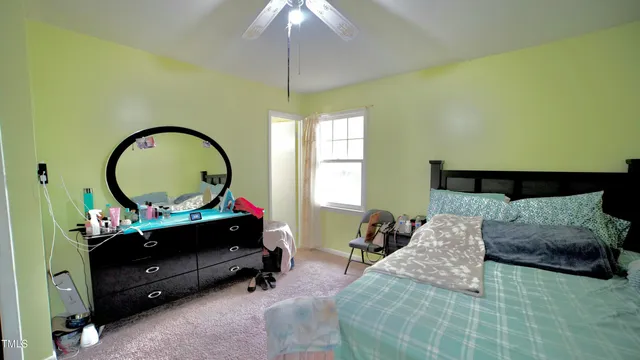 a bedroom with bed and a chandelier