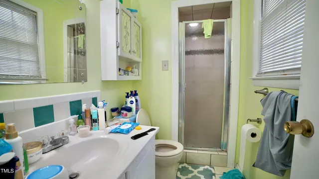 a bathroom with a sink toilet and shower
