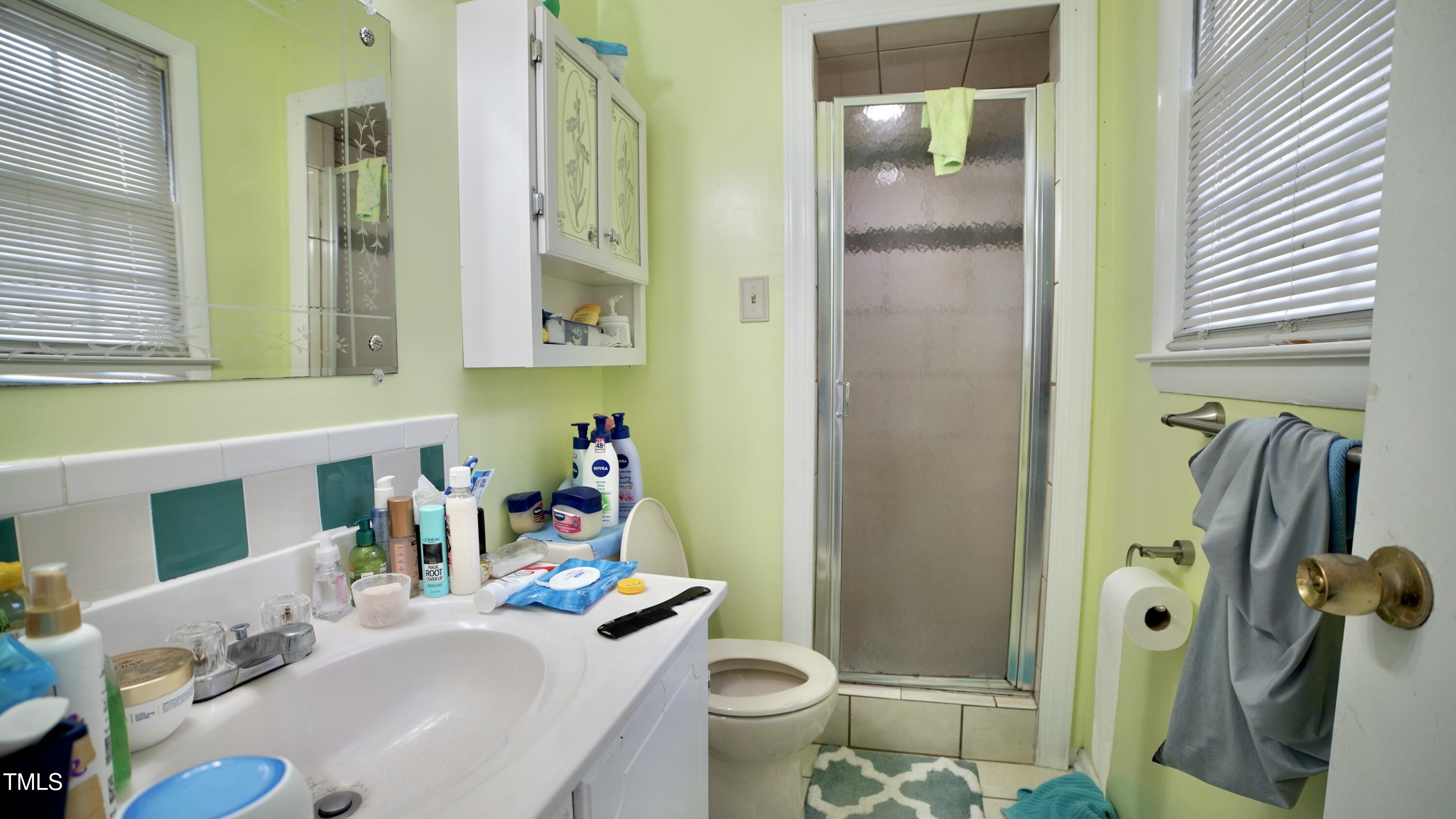1011 Wyldewood Road Durham, NC 27704 - Photo 13 of 18 a bathroom with a sink toilet and shower