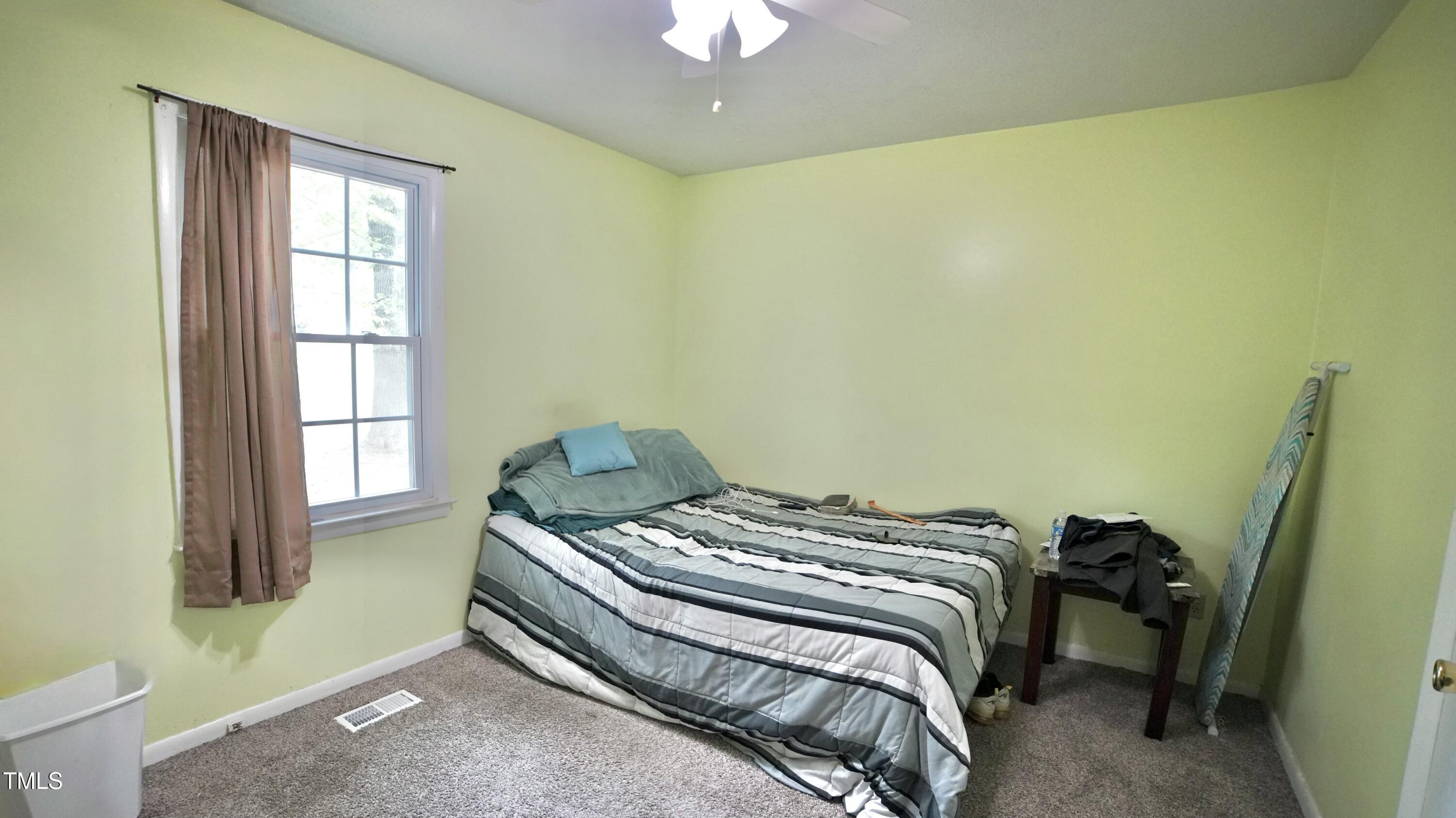 1011 Wyldewood Road Durham, NC 27704 - Photo 14 of 18 a bedroom with a bed and a window