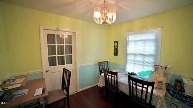 a view of a dining room with furniture and chandelier