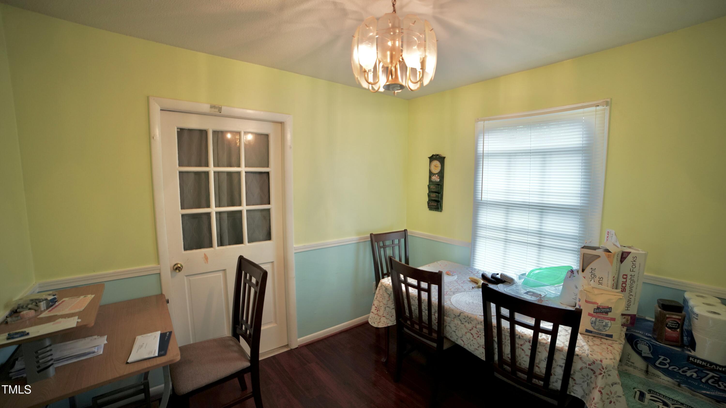 1011 Wyldewood Road Durham, NC 27704 - Photo 16 of 18 a view of a dining room with furniture and chandelier