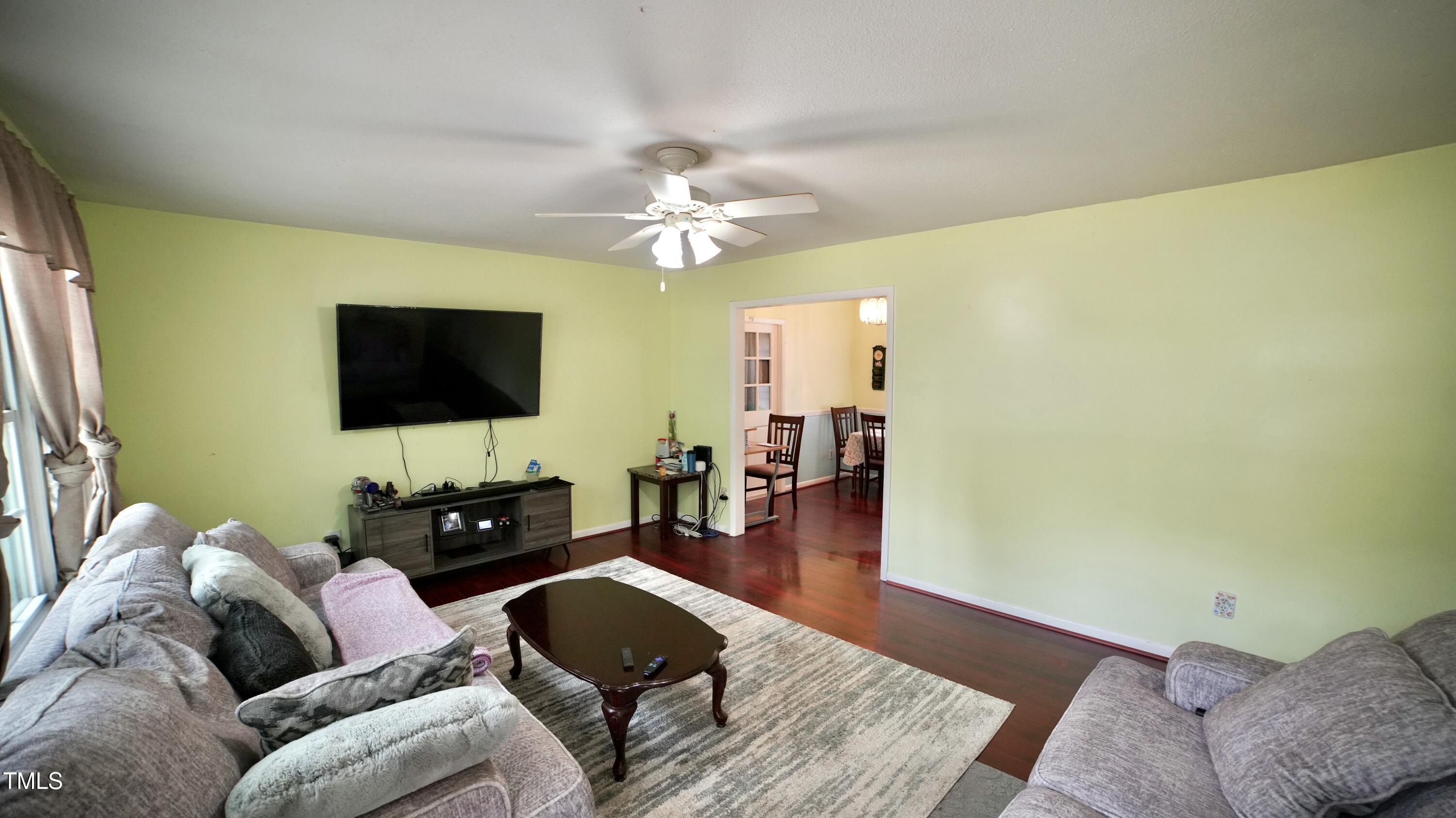 1011 Wyldewood Road Durham, NC 27704 - Photo 5 of 18 a living room with furniture and a flat screen tv