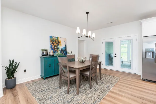 a kitchen with stainless steel appliances granite countertop a stove a sink and white cabinets