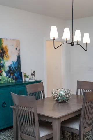 a kitchen with stainless steel appliances granite countertop a stove a sink a microwave a refrigerator and white cabinets