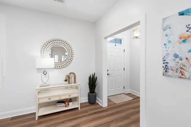 a living room with furniture kitchen view and a table