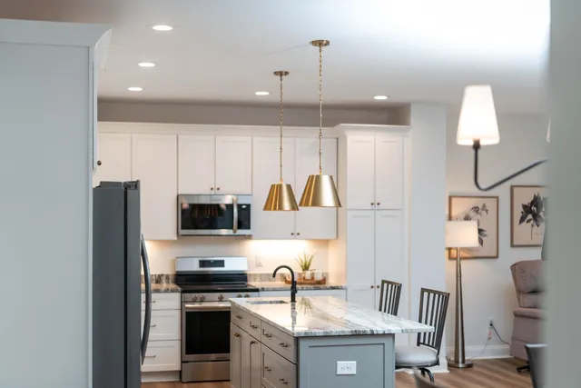 a kitchen with stainless steel appliances granite countertop a stove oven and a refrigerator