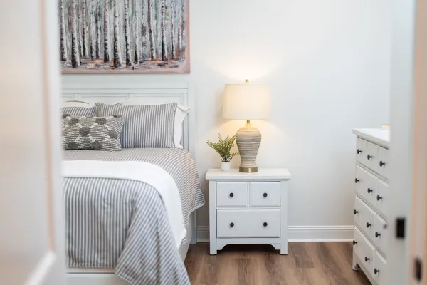 a spacious bedroom with a bed a window and closet