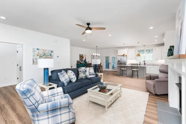 a living room with a fireplace and a painting on the wall