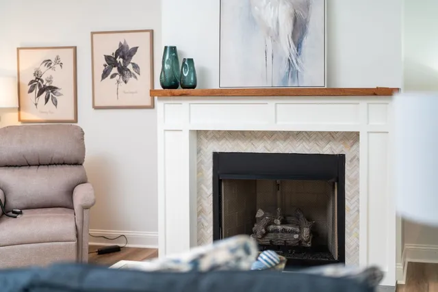 a view of a hallway with entryway wooden floor and a fireplace