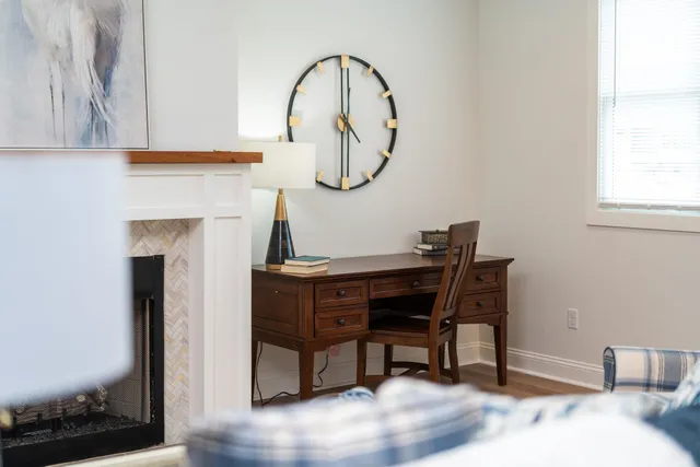 a living room with furniture a window and gym equipment