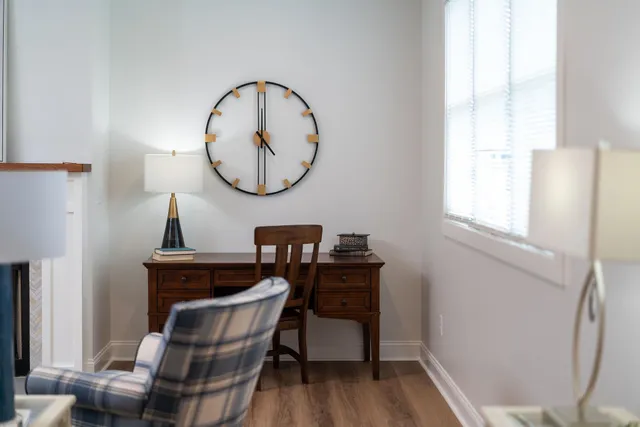 a view of a dining room with furniture a rug and wooden floor
