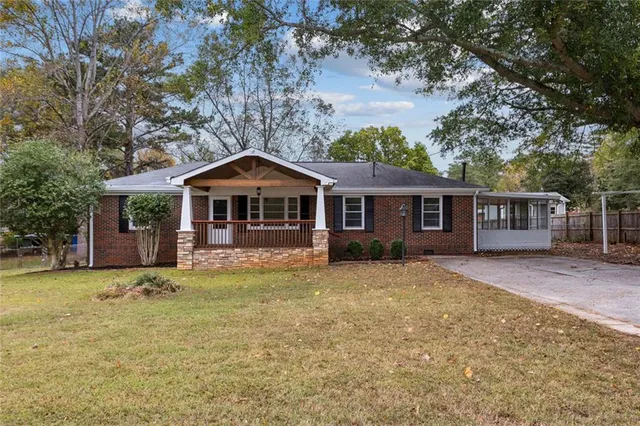 a front view of a house with yard porch and furniture