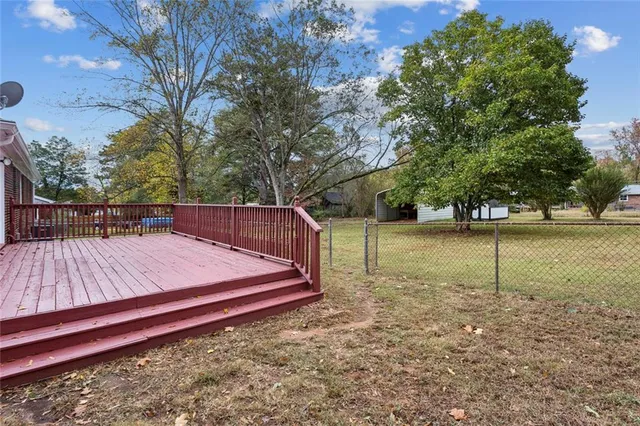 a view of a backyard with large trees