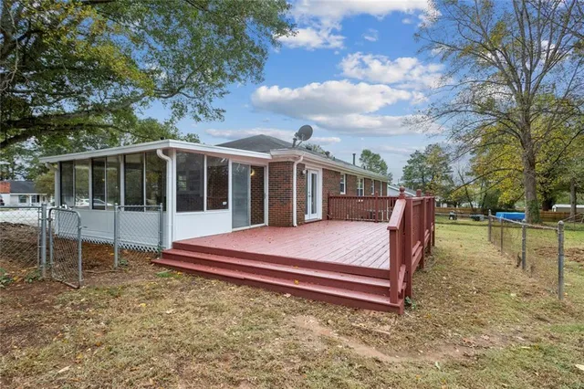 a view of a house with backyard and sitting area