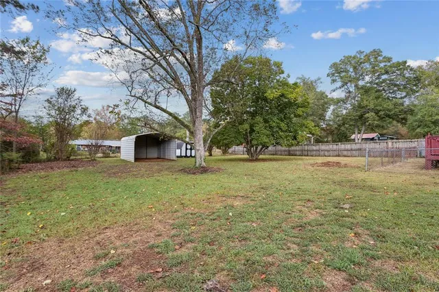 a view of outdoor space with garden and trees