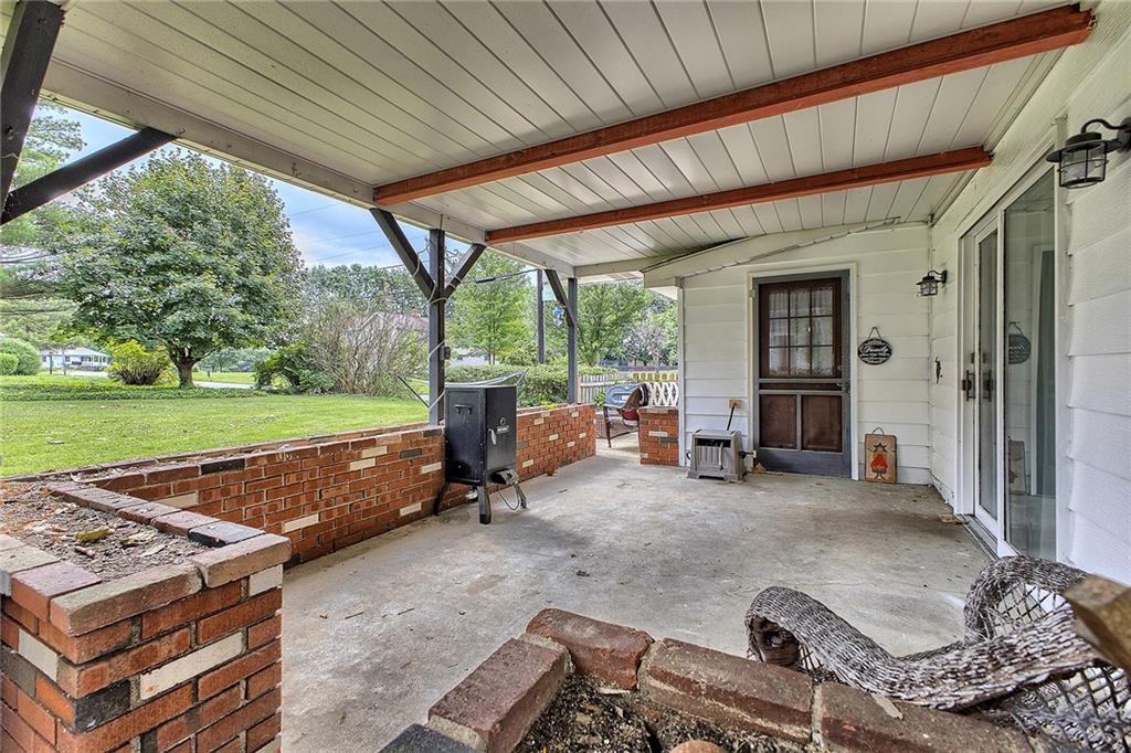 3456 Country Club Road Mount Pleasant, PA 15666 - Photo 15 of 39 a backyard of a house with barbeque oven table and chairs