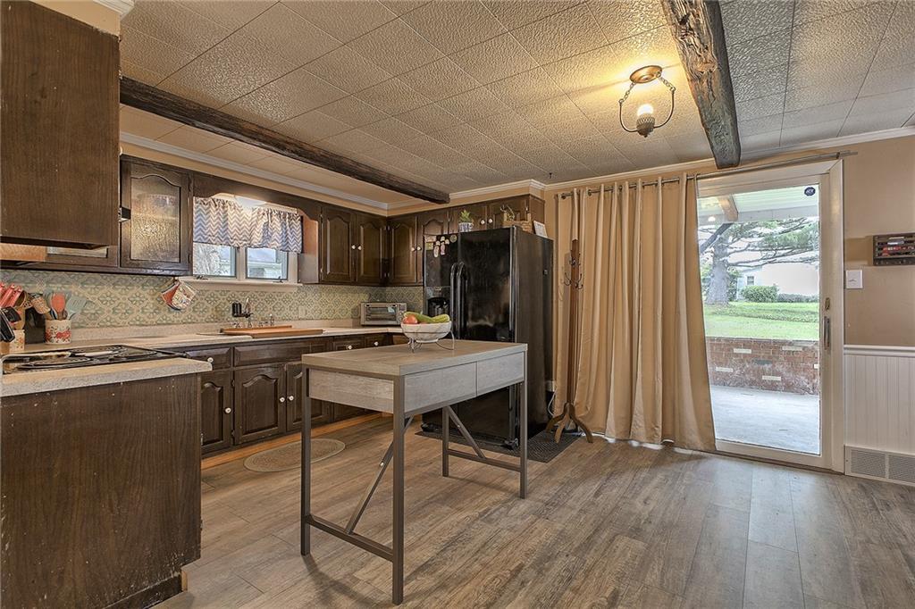 3456 Country Club Road Mount Pleasant, PA 15666 - Photo 19 of 39 a kitchen with a table chairs refrigerator and cabinets